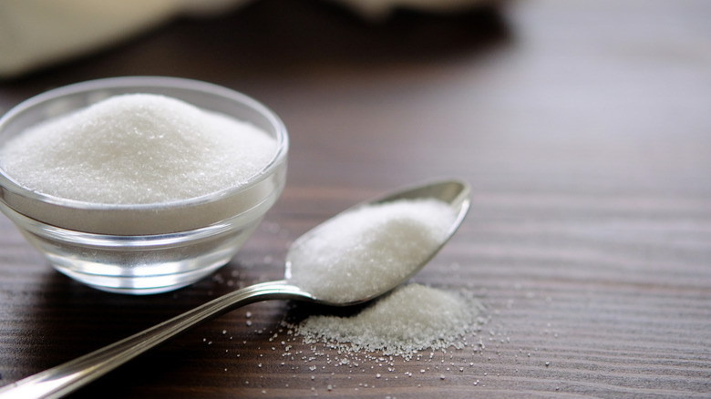 Salt in bowl, with spoon of salt next to it