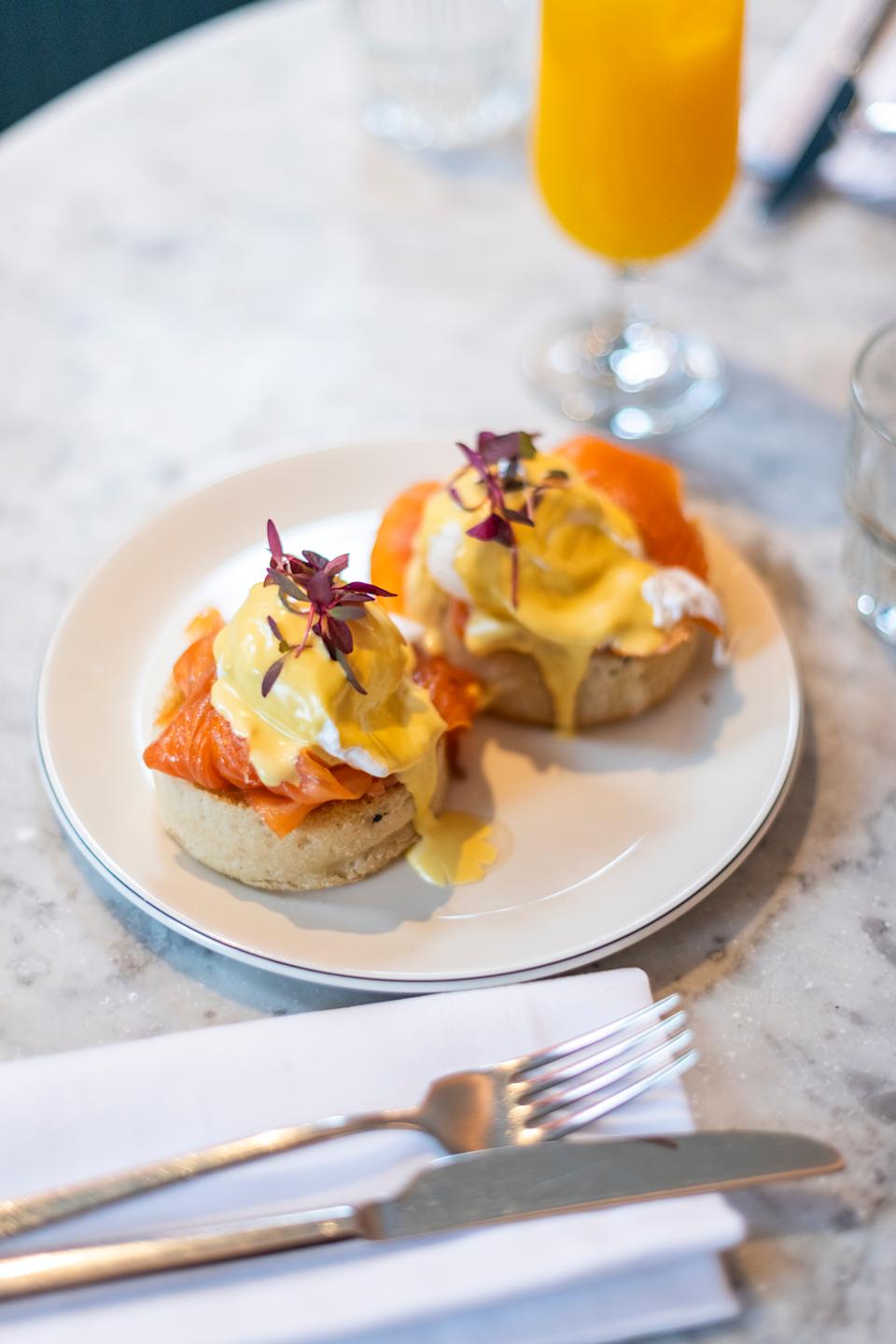 Poached eggs with Hollandaise sauce and Smoked Salmon on toasted muffins in a restaurant