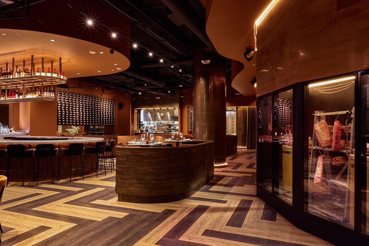 Aris’s bar area, with views into the open kitchen and meat locker.