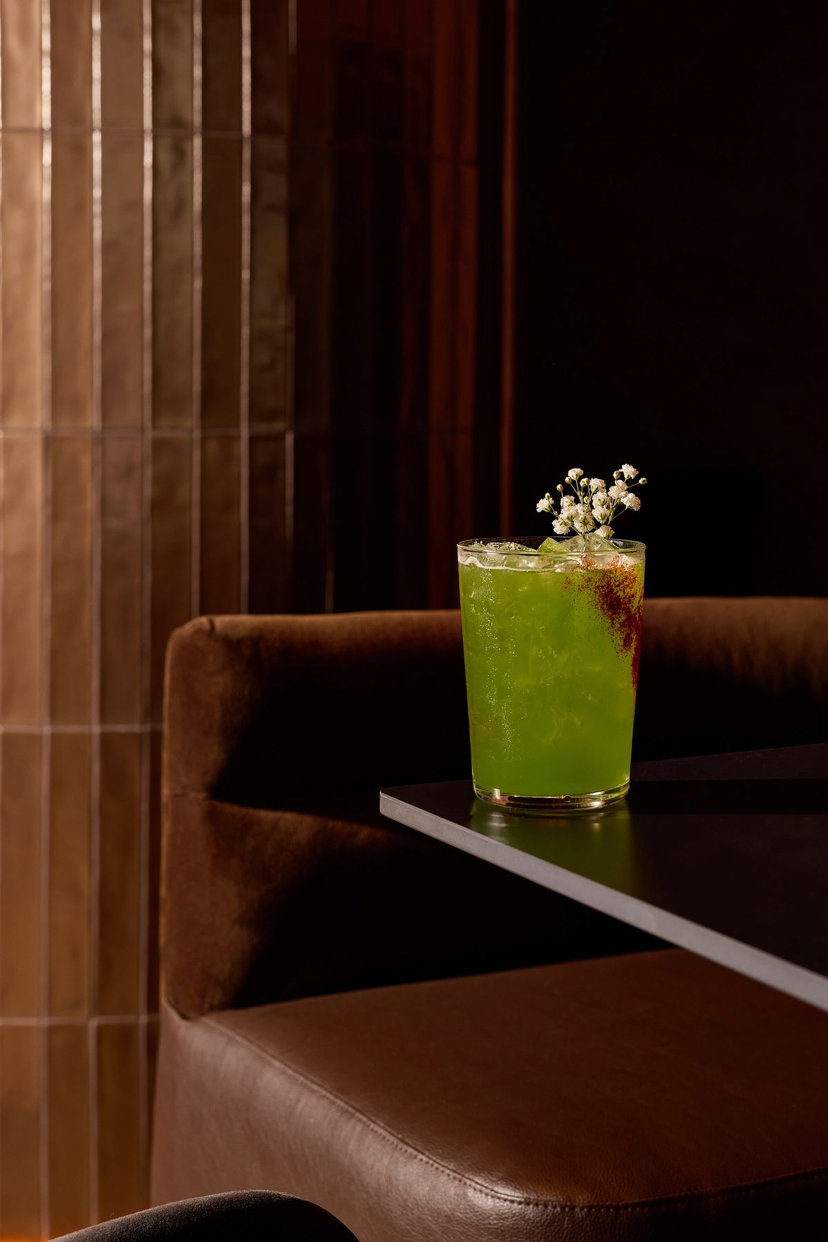 A cocktail garnished with Babies Breath Flowers at Aris.