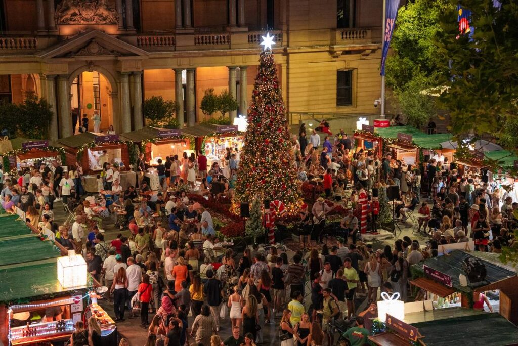People shopping and dining around the Christmas tree at Le Jolly Market in Sydney