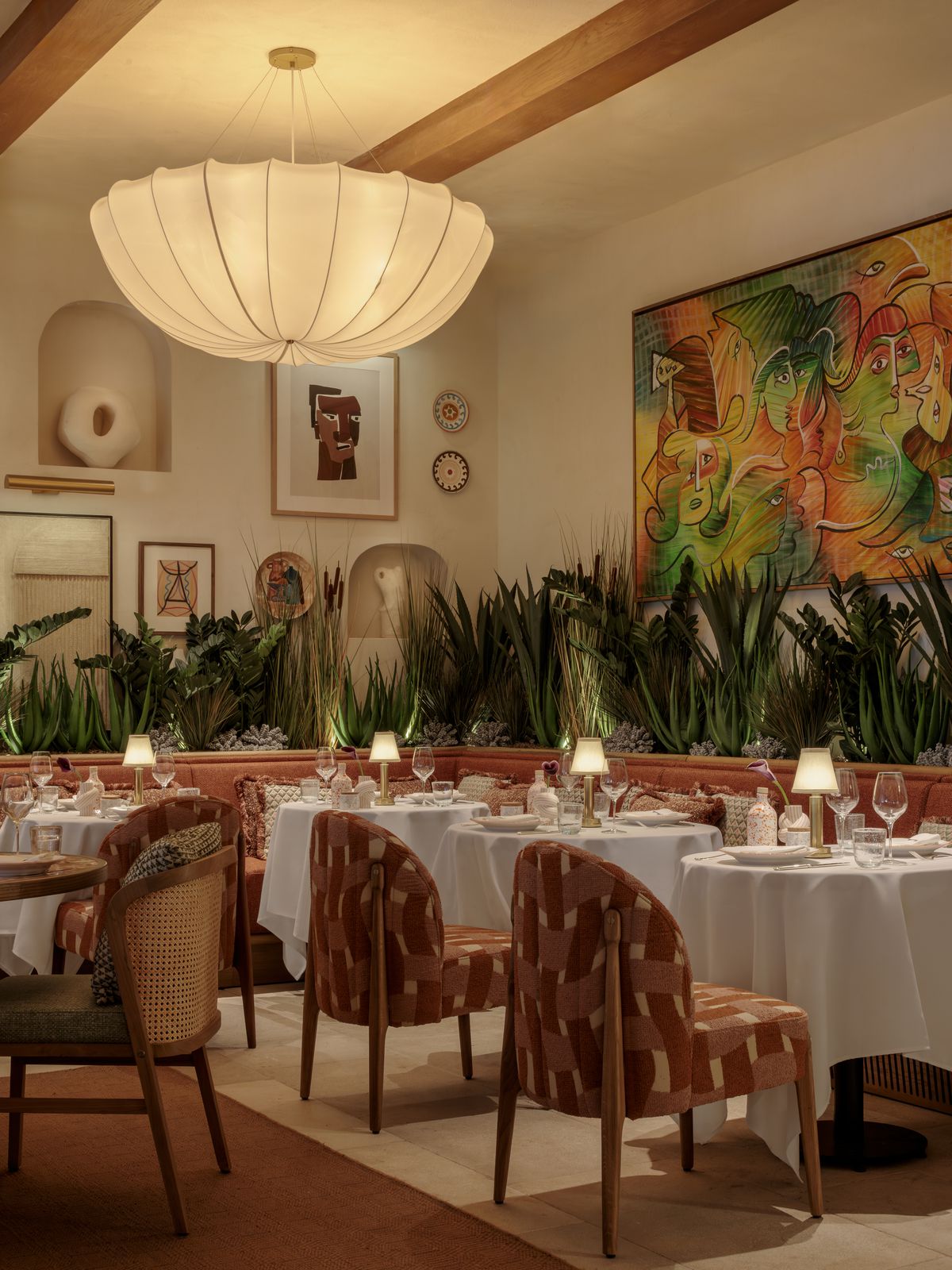 A large, glowing lamp that looks like an upside-dow umbrella. 