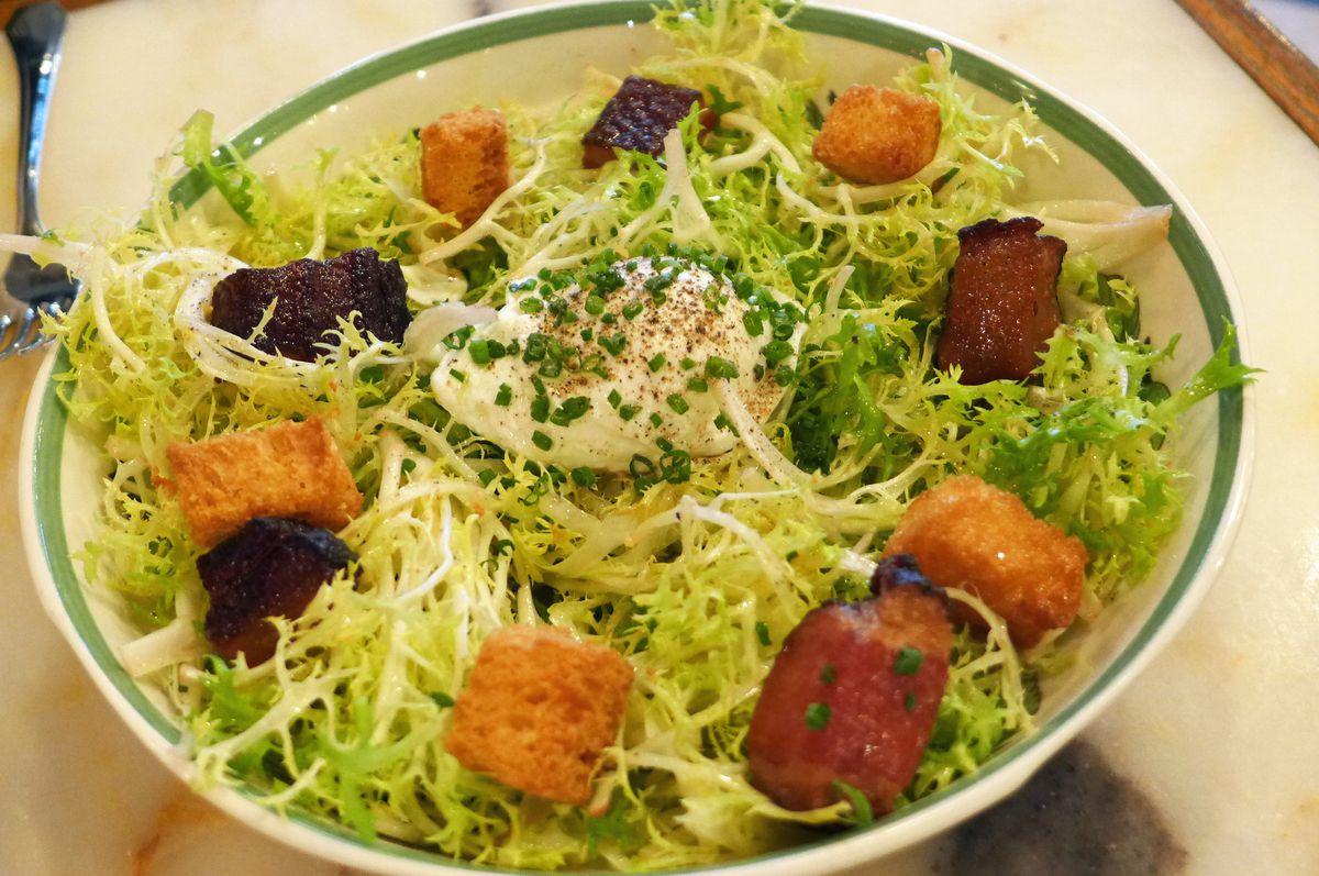 A salad of chicory with bacon and croutons.