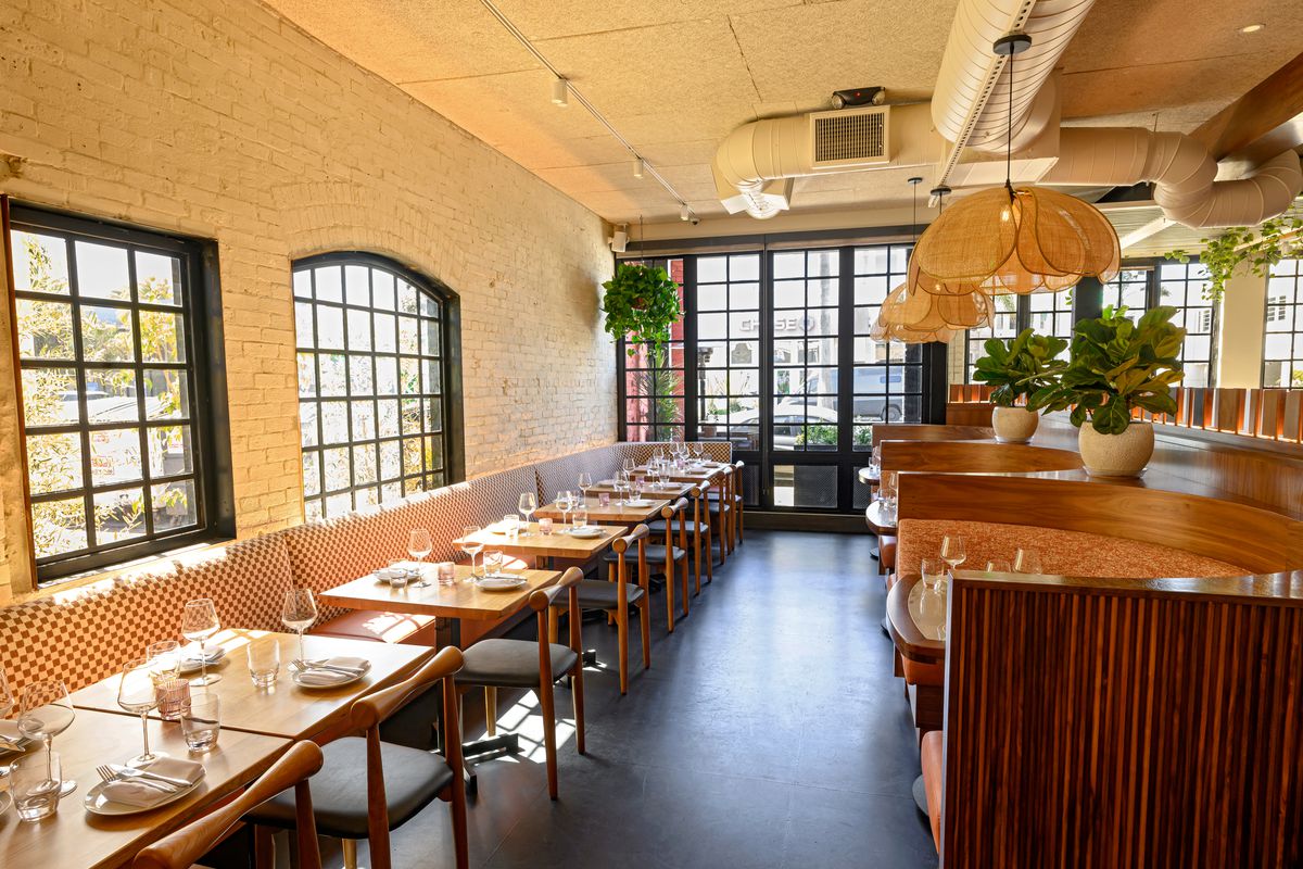 Banquette seating surrounded by large windows at Attagirl in Hermosa Beach.