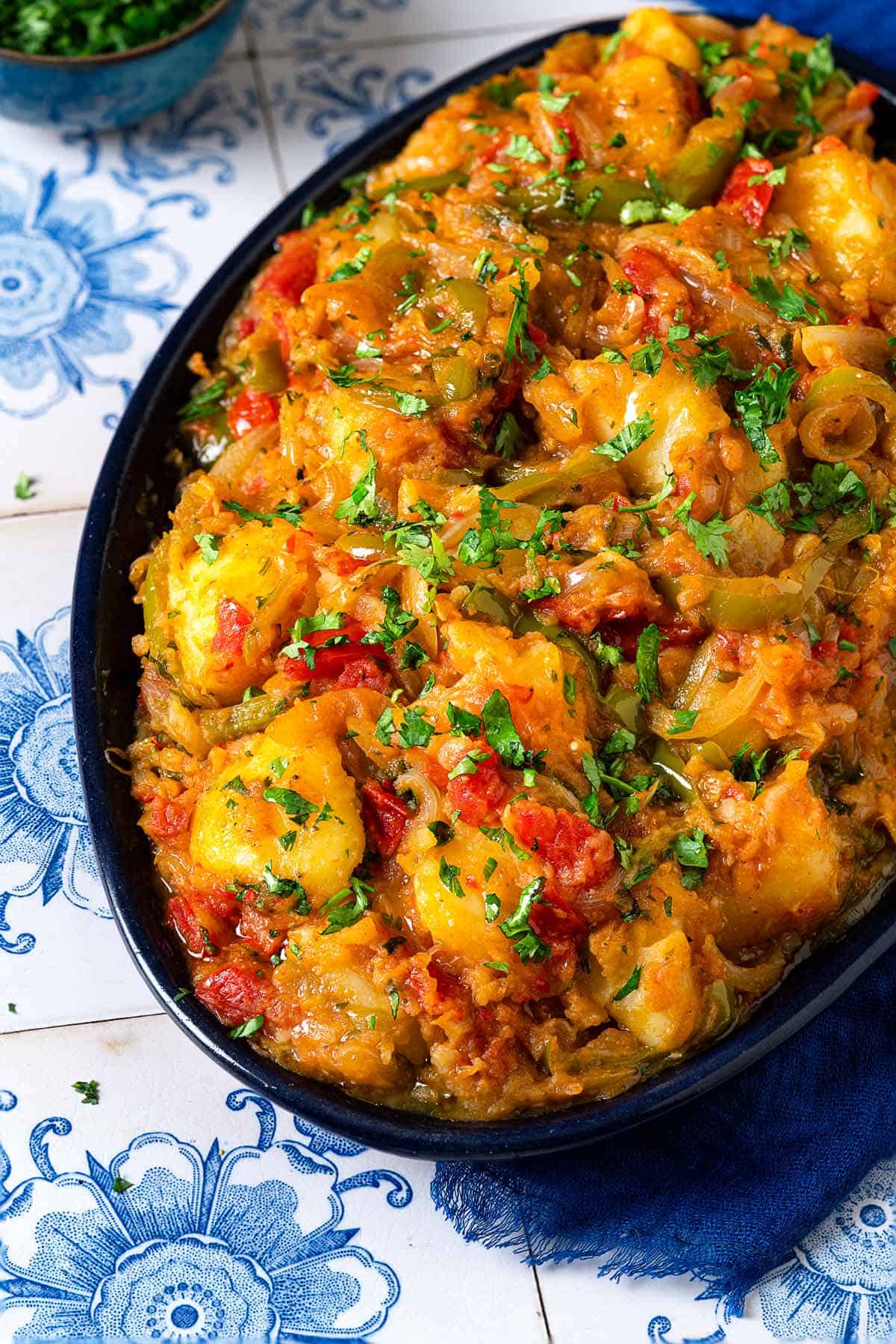 close up of dopiazeh aloo perisan potato curry in a serving bowl.