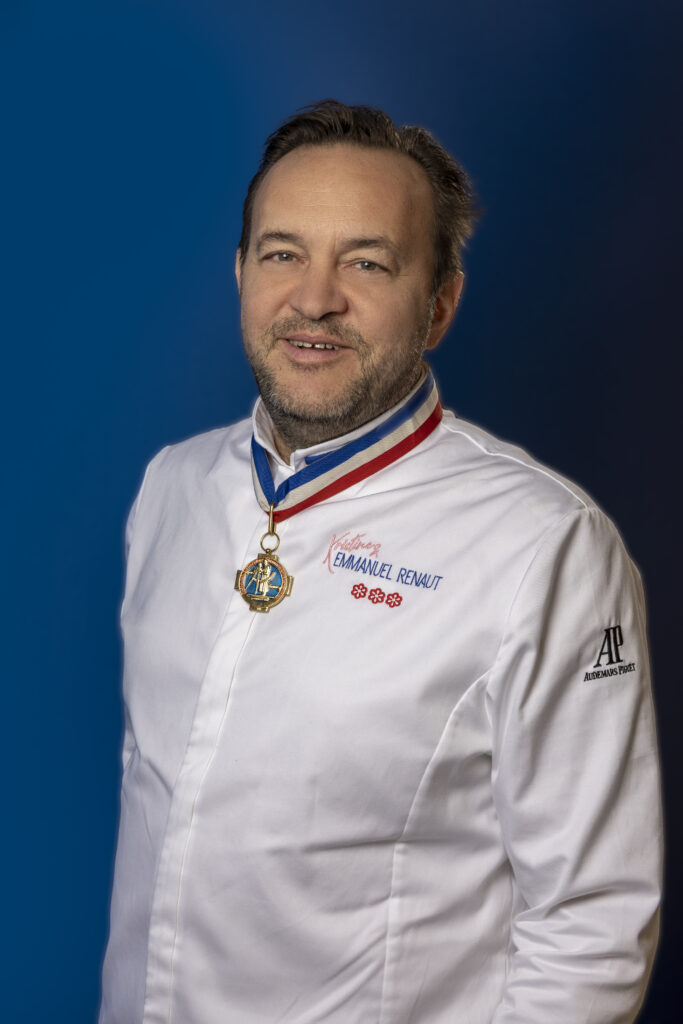 Emmanuel Renaut is pictured in his chef uniform against a blue background.