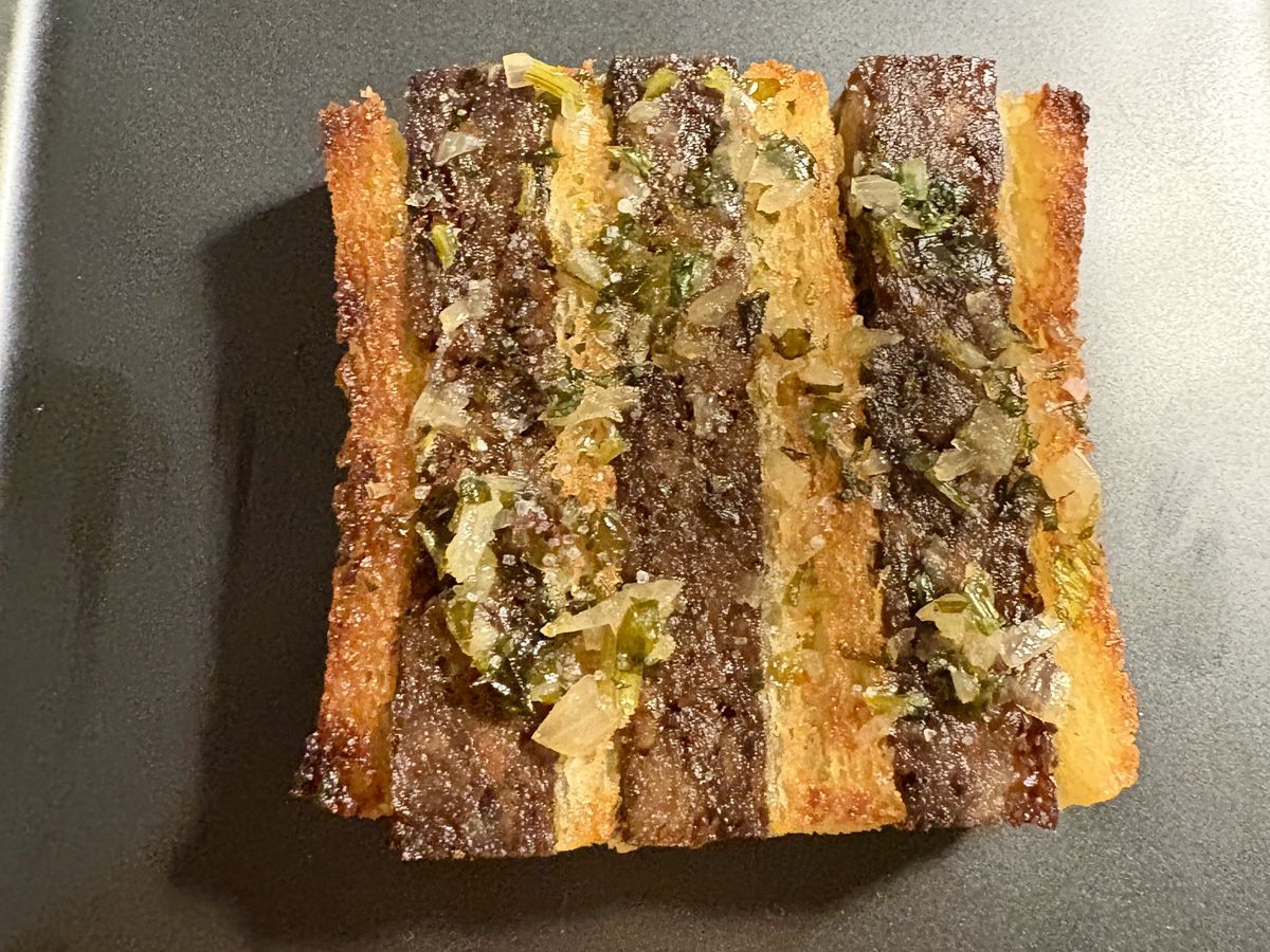 A plate of oxtail croque monsieur.