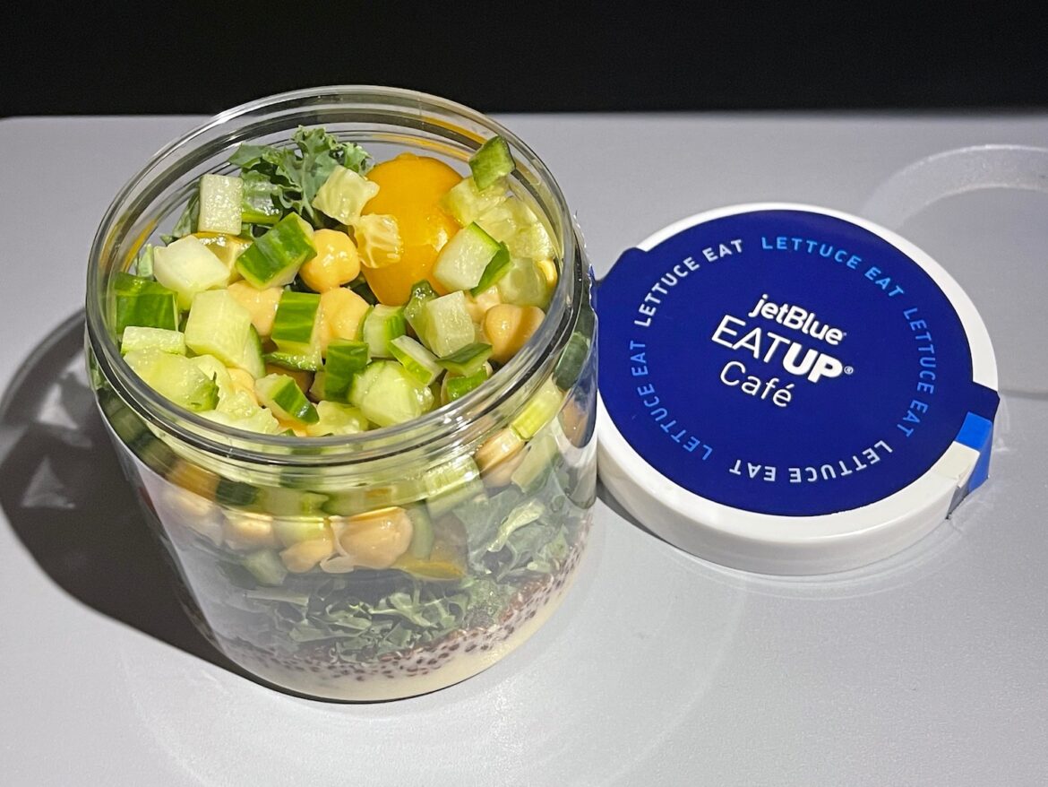 Mediterranean Salad On JetBlue – Live and Let’s Fly a jar of salad with vegetables and a blue lid