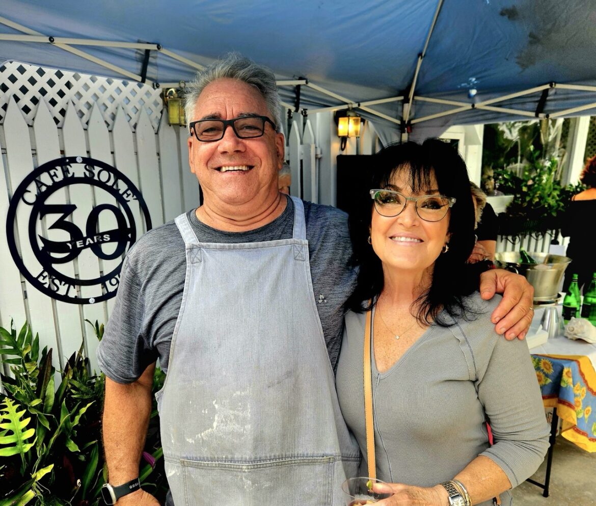 a man and a woman standing under a tent