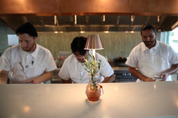 Chefs prepare dishes on Friday evening, Oct. 4, 2024, at...