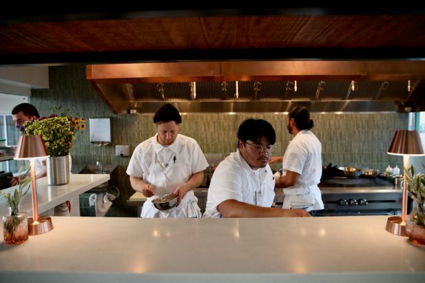 Chefs prepare dishes on Friday evening, Oct. 4, 2024, at...