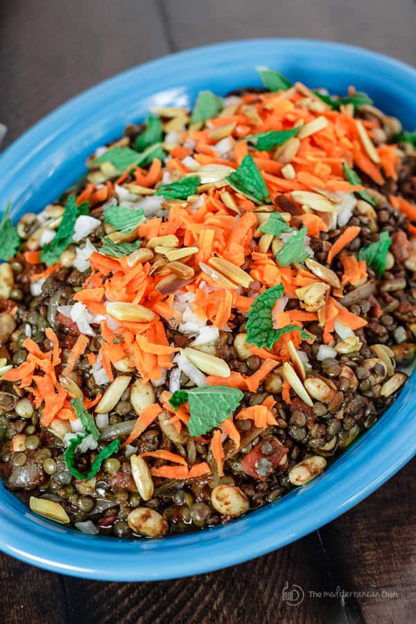 Harissa Lentil Salad Recipe | The Mediterranean Dish. A spicy lentil salad with white beans, tomatoes, Middle Eastern spices and harissa paste. A flavor-packed salad or side dish! Comes together in mins. See this recipe and more on TheMediterraneanDish.com