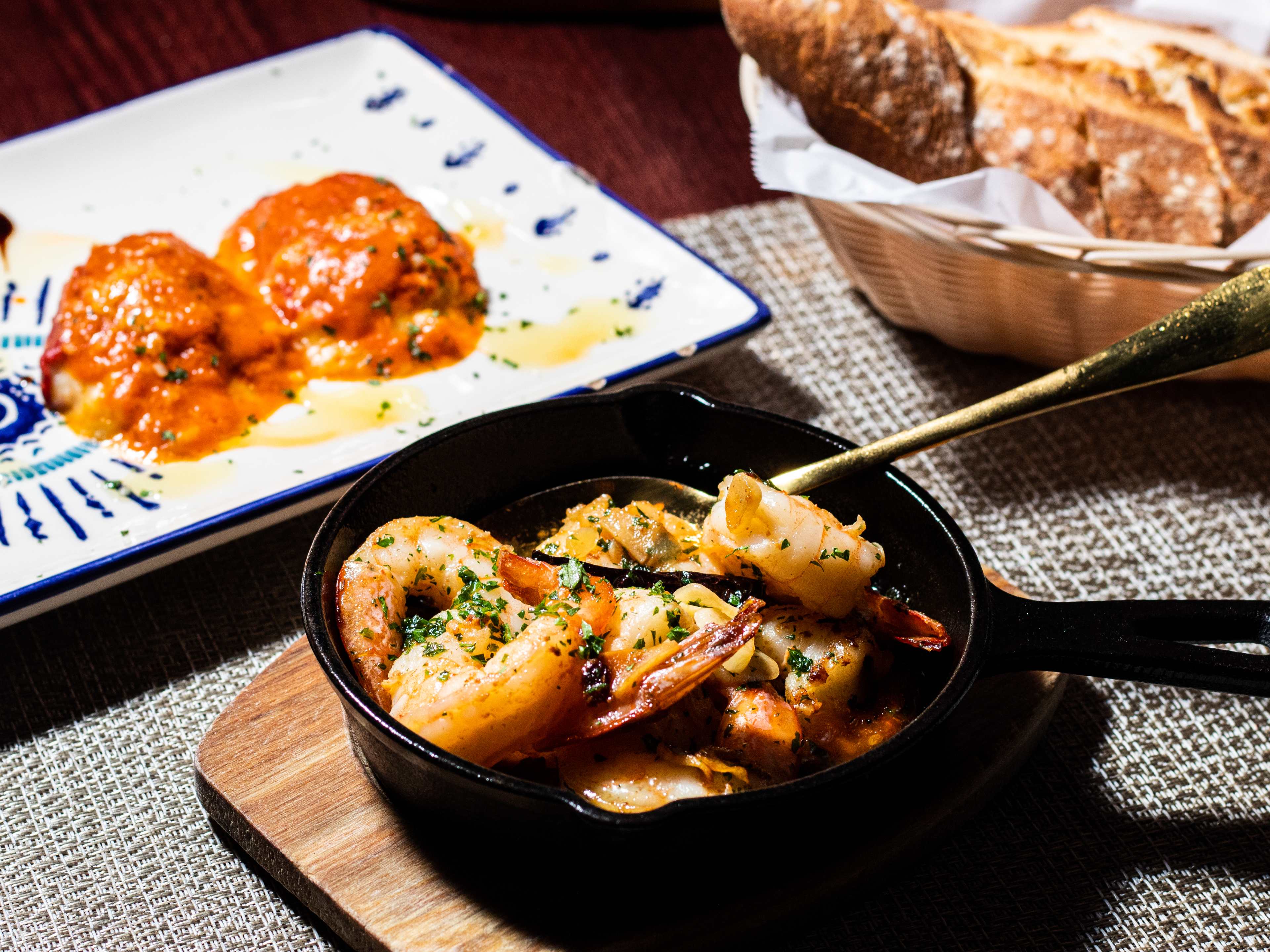 spread of stuffed peppers, bread, and shrimp