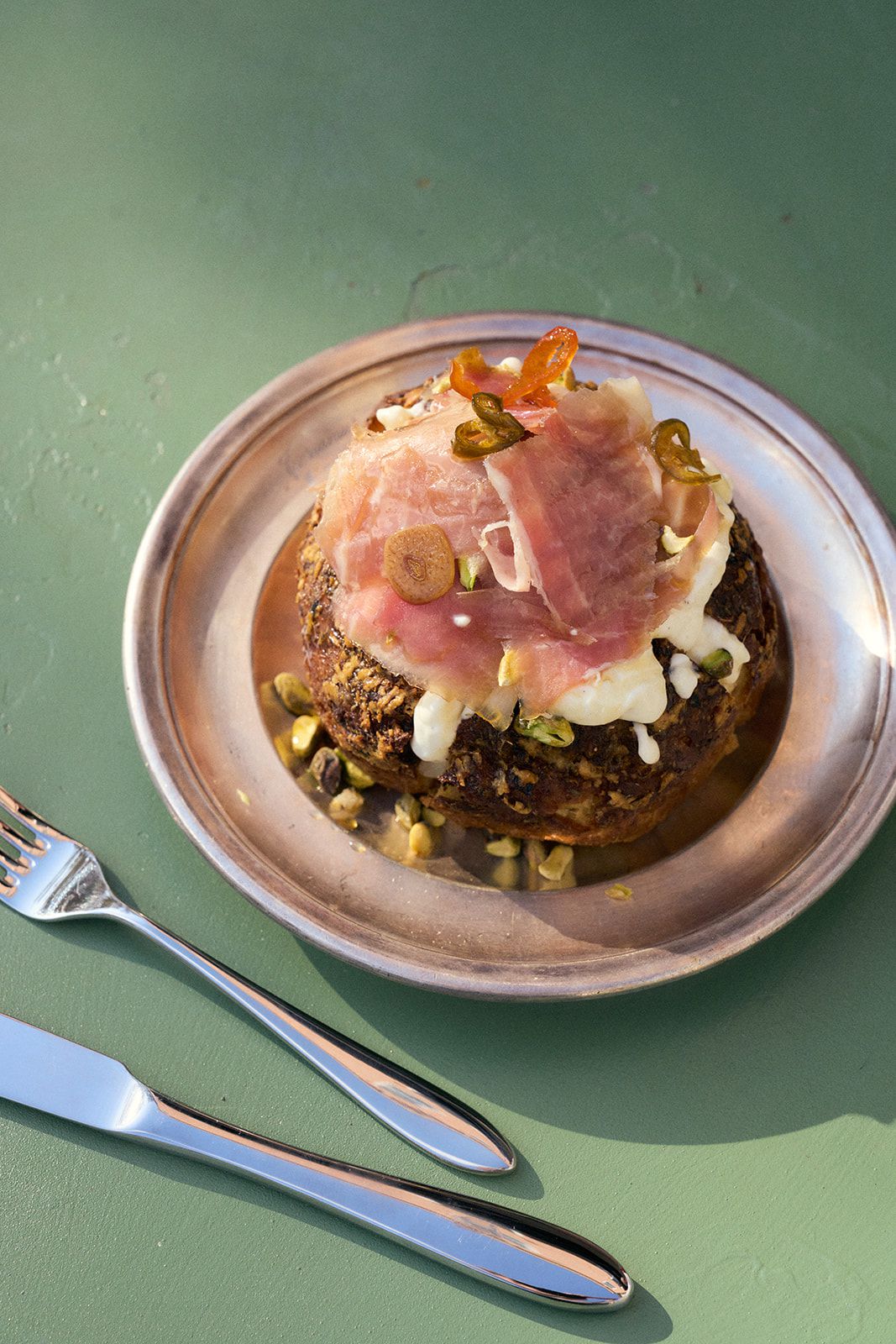 A small loaf of bread topped with ham and cheese.