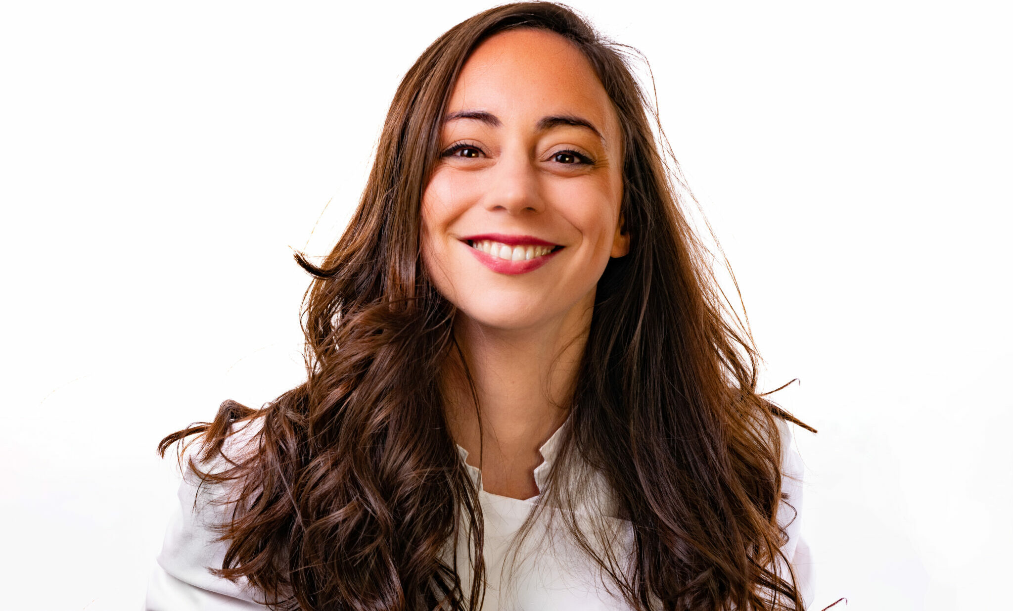 Nina Métayer is pictured smiling, against a white backdrop.