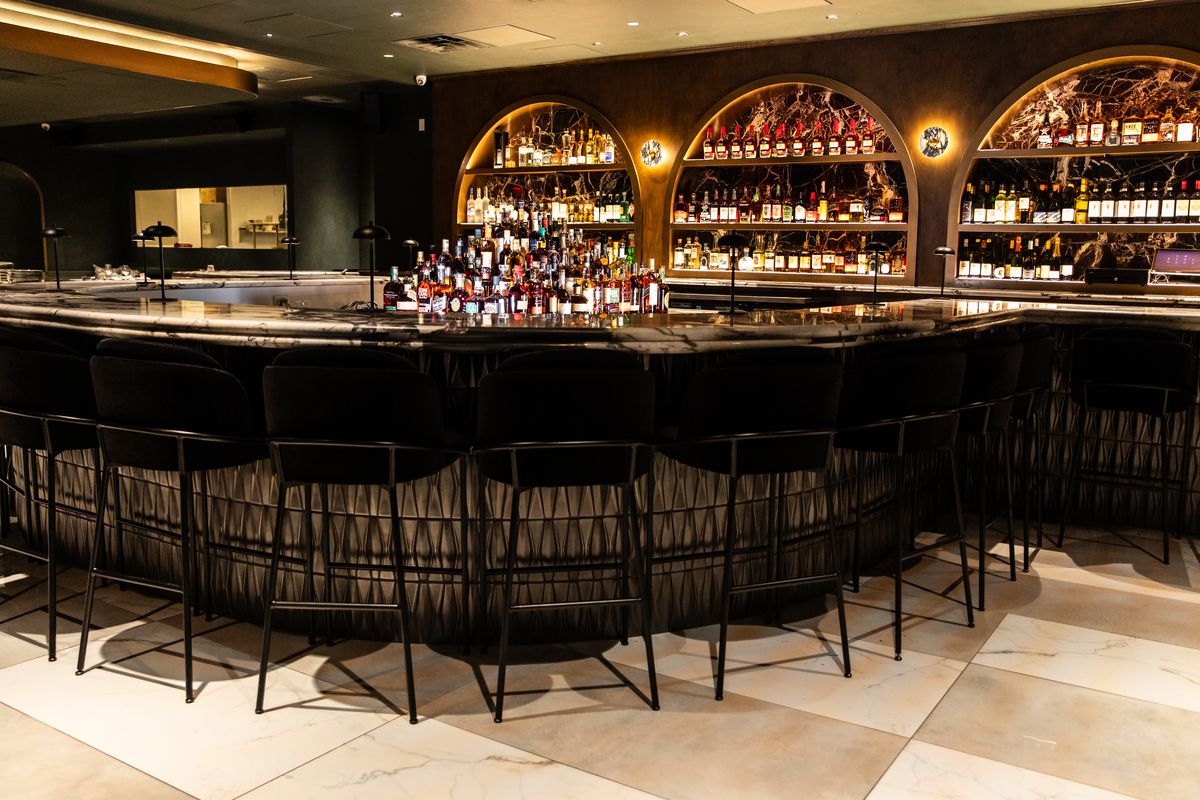 Okto’s illuminated bar, which is lined with liquor.