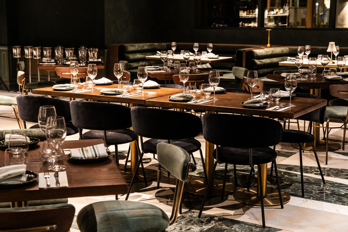 Okto’s dining room with tables lined with wine glasses.
