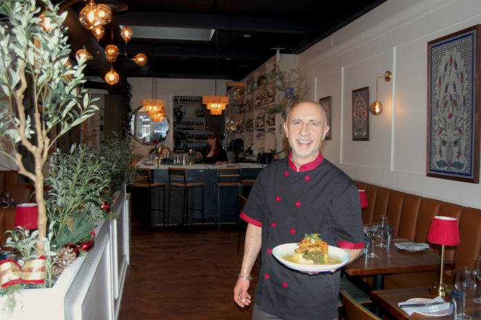 Opelia owner with chicken dish