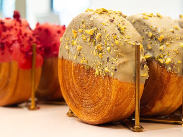 A dipped croissant at Desserts by Clément. Several types of the sweet and savory croissants are a specialty of the bakery. (Voila Creative Agency)