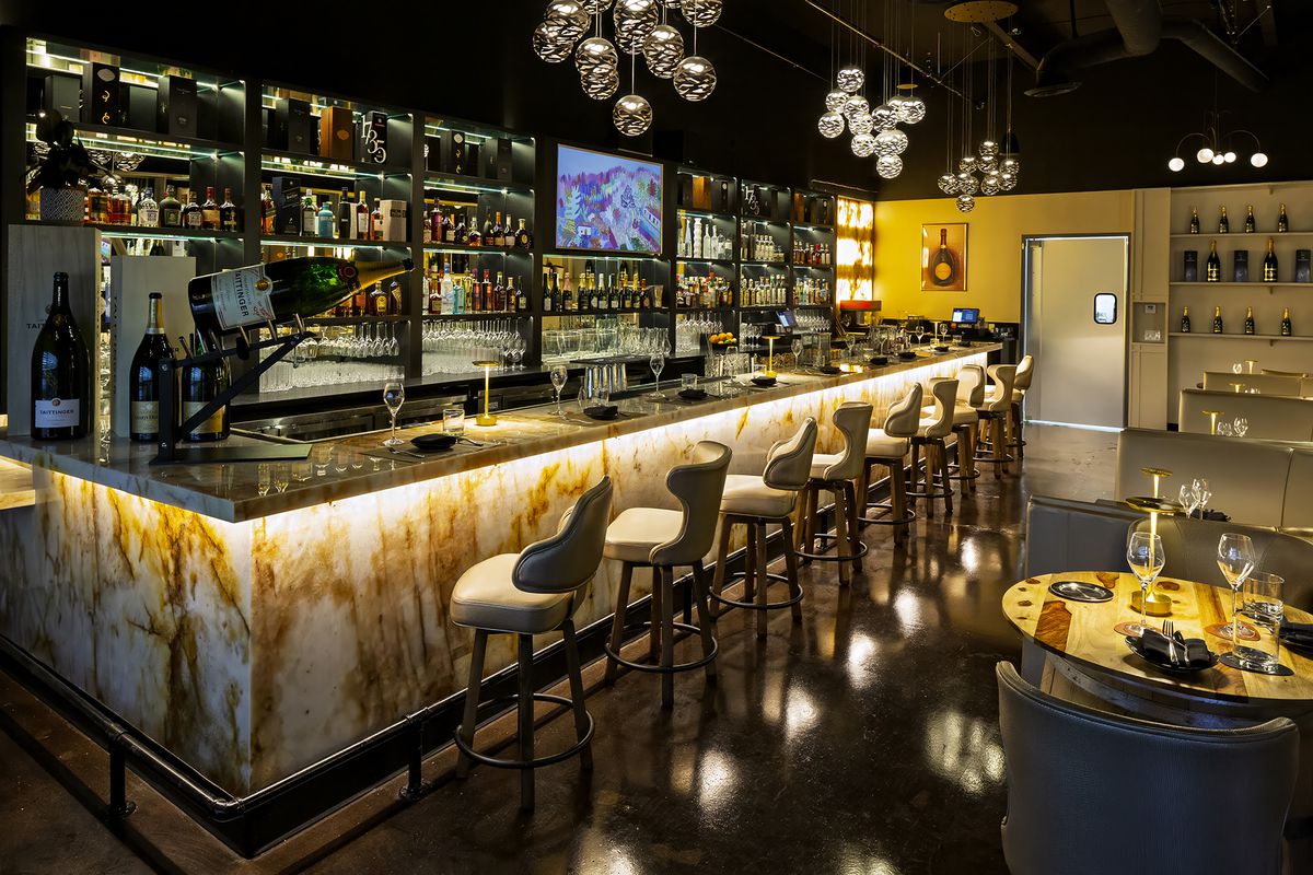 A bar with barstools at Le Club