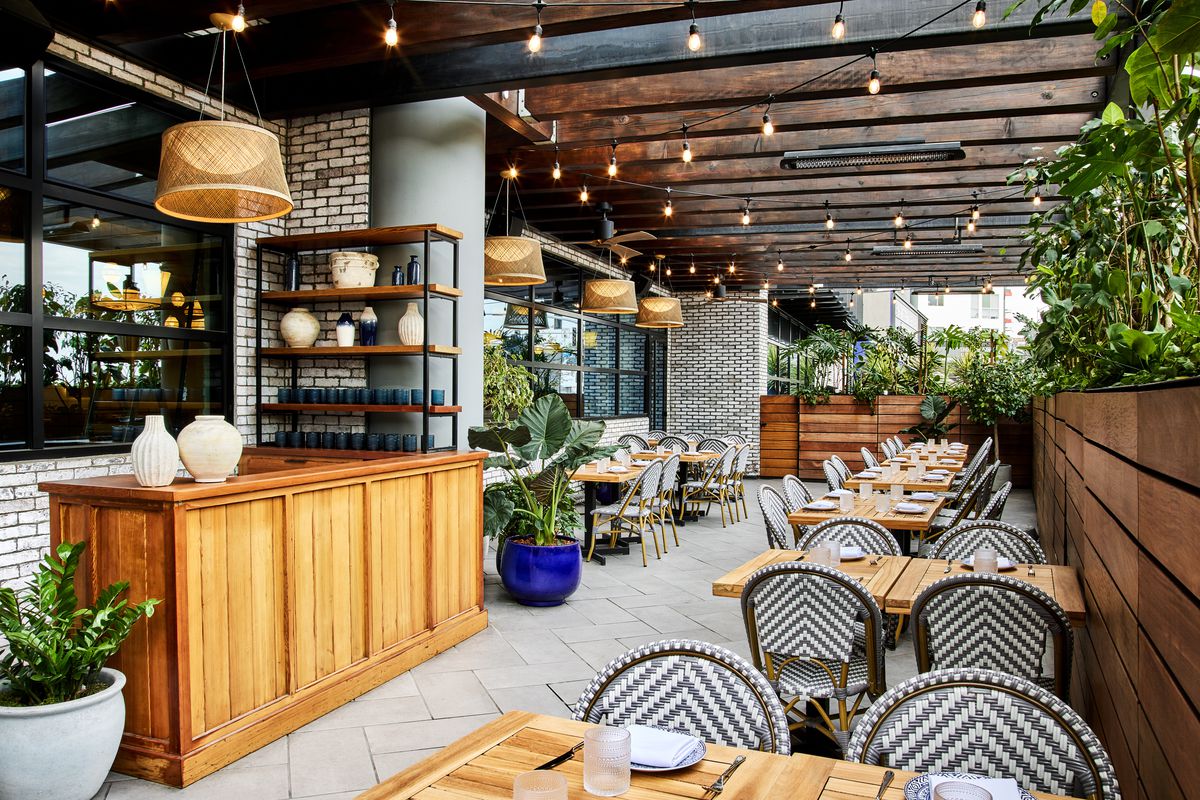 A well-lit patio with greenery and patio seating at Zaytinya.