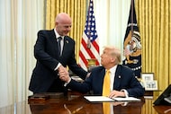 President Donald Trump, right, and FIFA President Gianni Infantino shake hands after Trump...