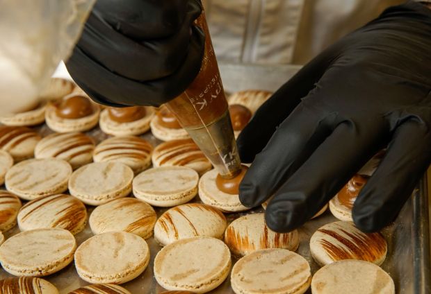 Malek Larbi, corporate chef makes coffee macarons in the commissary kitchen in Middletown on Tuesday, Oct. 22, 2024 in San Diego, California. (Alejandro Tamayo / The San Diego Union-Tribune)