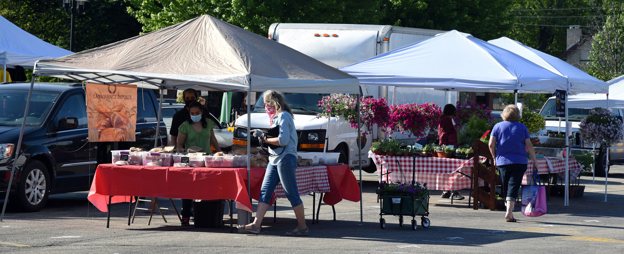Center, with pink face bandana, Carol Macejak, a Morton Grove resident, shops for baked goods. Images from the opening day of the Morton Grove French Market in Morton Grove on June 6, 2020 at 6140 Dempster St.