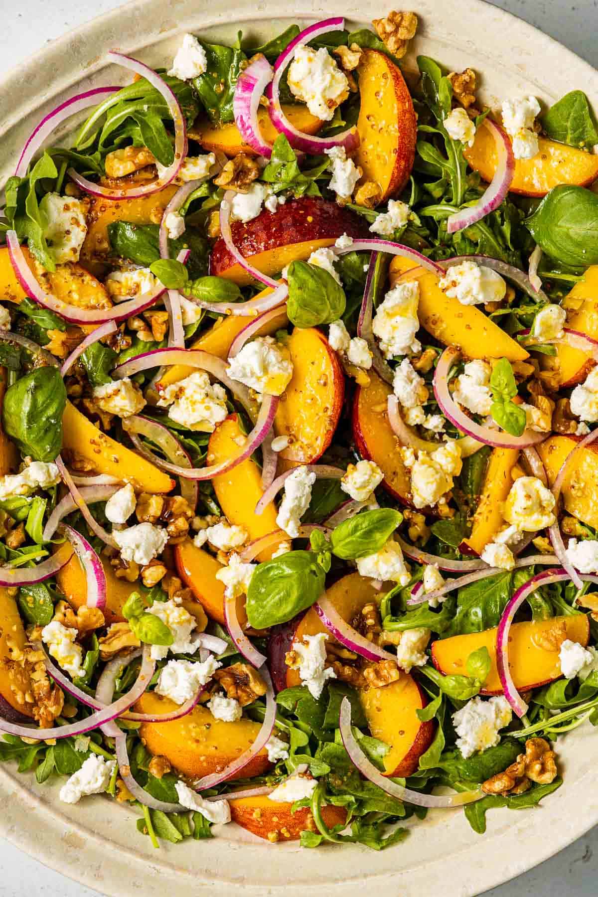 close up of a peach salad in a serving bowl.