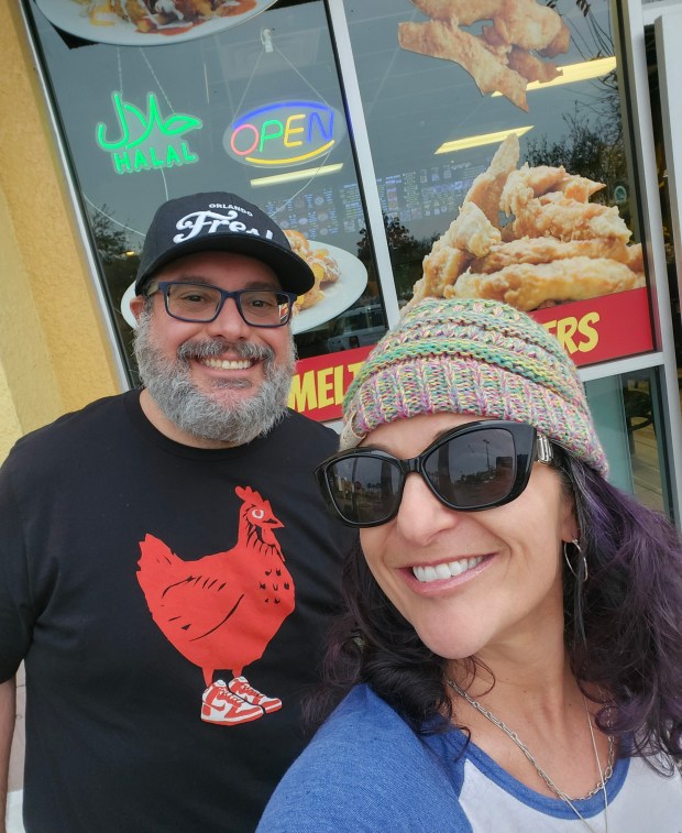 Chicken Run! Orlando Sentinel food reporter Amy Drew Thompson and Deli Fresh Threads' Anthony "Biggie" Bencomo strike a pose outside Huey Magoo's, which wound up ruling the roost when it came to chain chicken tenders. (Amy Drew Thompson/Orlando Sentinel)