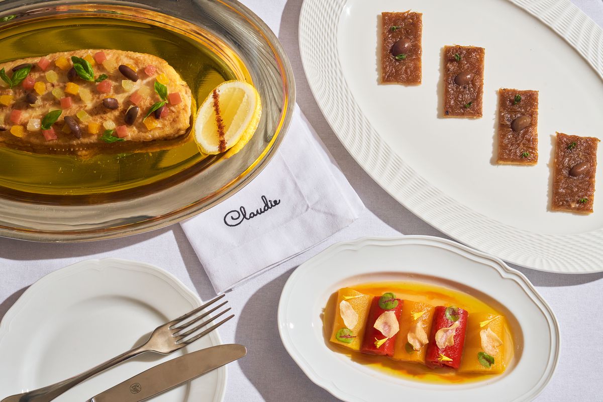 A silver platter topped with a filet of fish, next to a plate of more fish. 