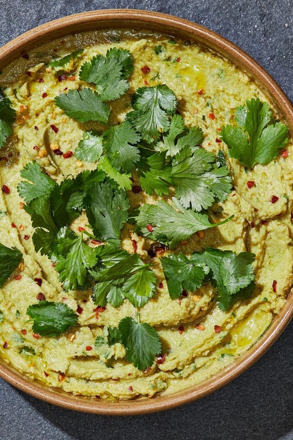 avocado hummus topped with red pepper flakes and cilantro