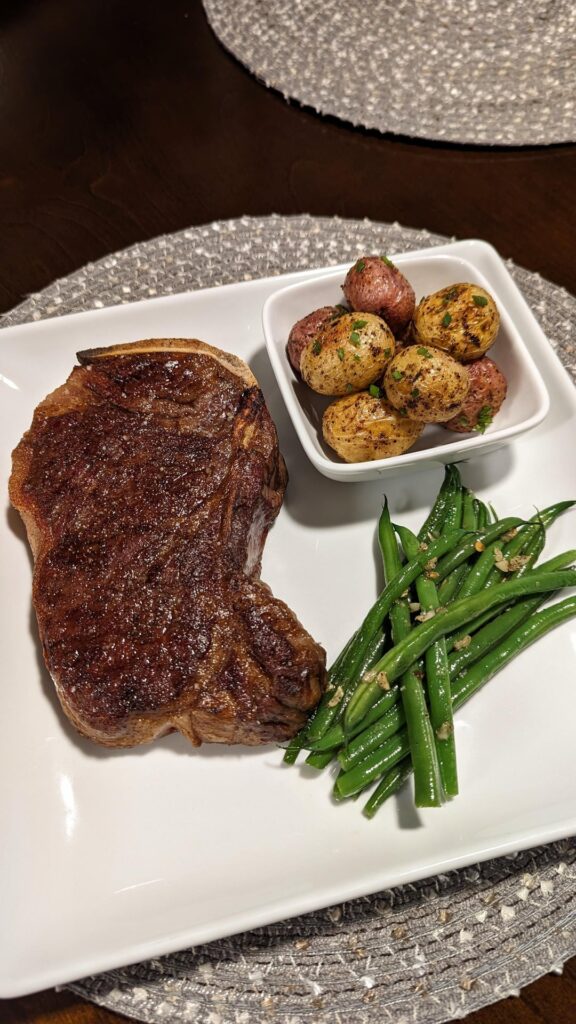 Kansas City Strip with Roasted Potatoes and Garlic Green Beans