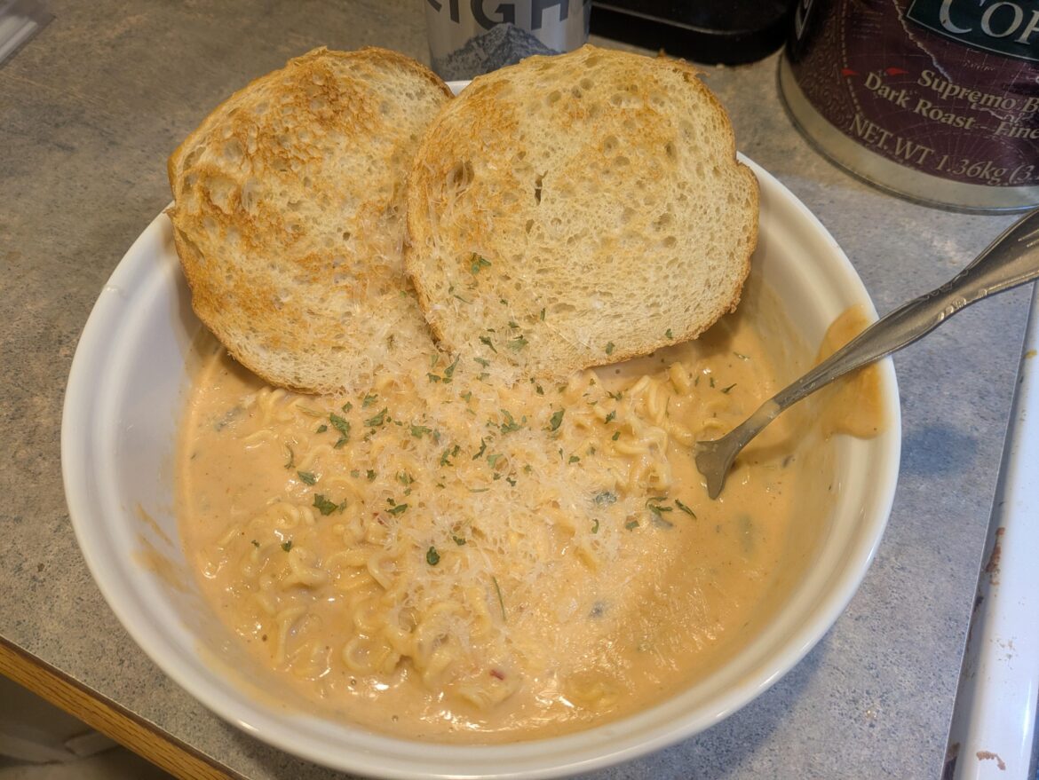 Cream of mushroom soup with red Shin ramen, sourdough toast, and shredded asiago cheese.