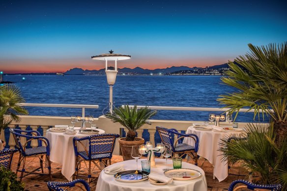 The Mediterranean glimmers beyond the arched windows at La Passagere.