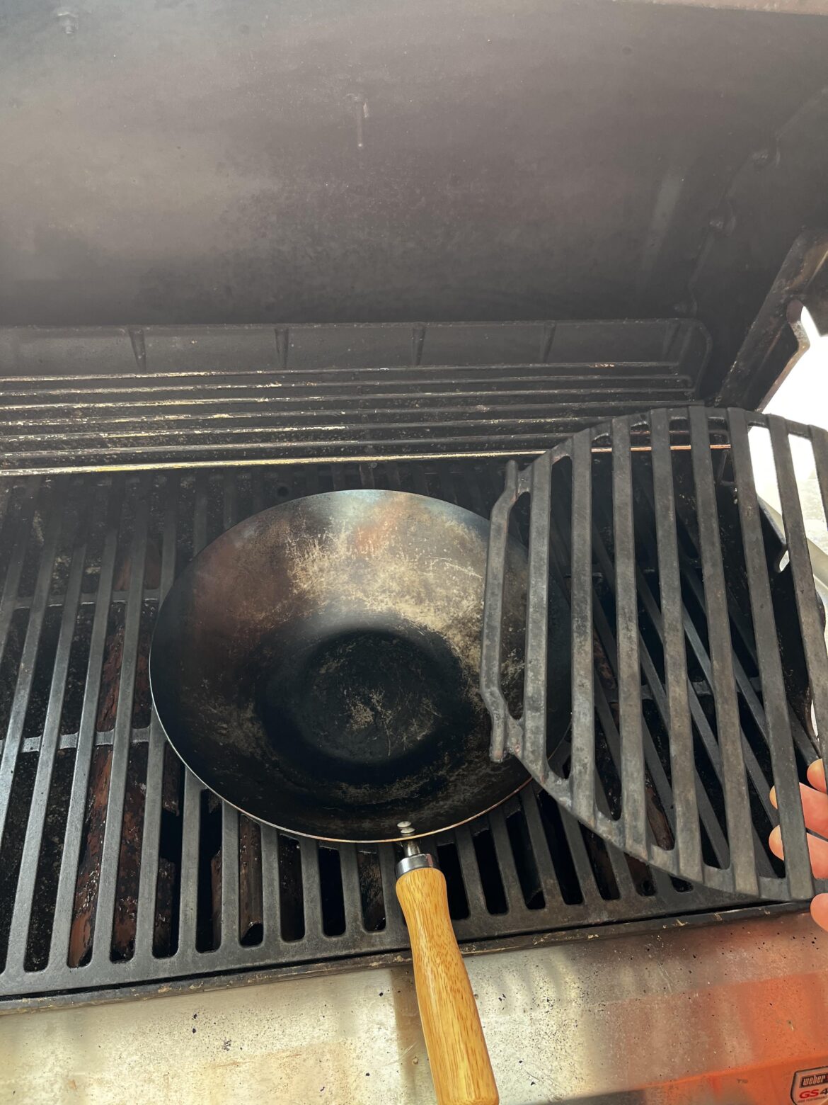 Turns out that removing the centerpiece of your grill makes for a perfect hole for a wok