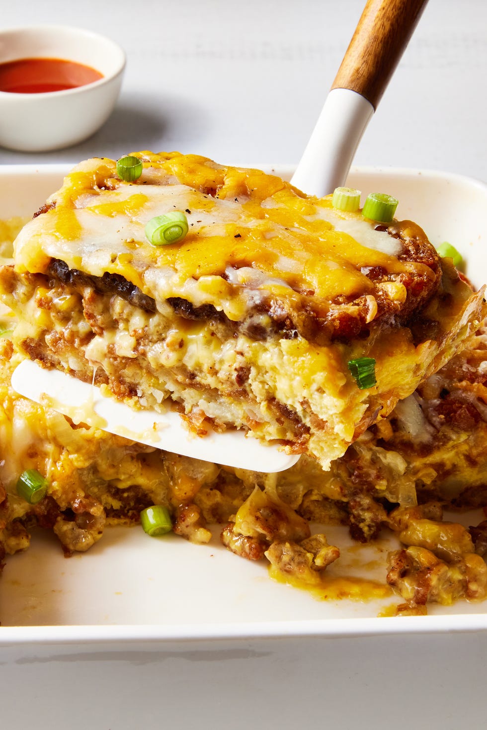layered hashbrowns, eggs, and sausage topped with cheese and baked in a casserole dish