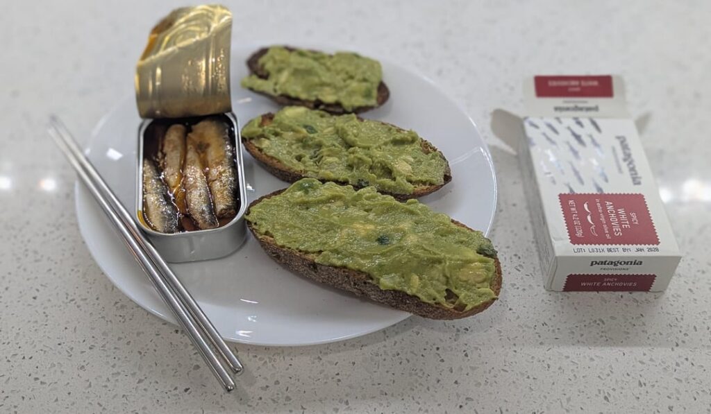 Spicy white anchovies in EVOO with sourdough avocado toast