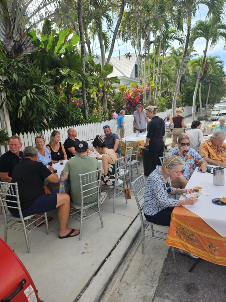 a group of people sitting around a table eating food