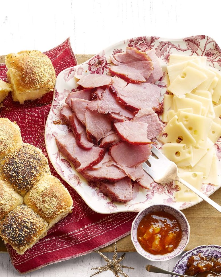 honey glazed ham and checkerboard rolls with cheese slices and jam in bowl