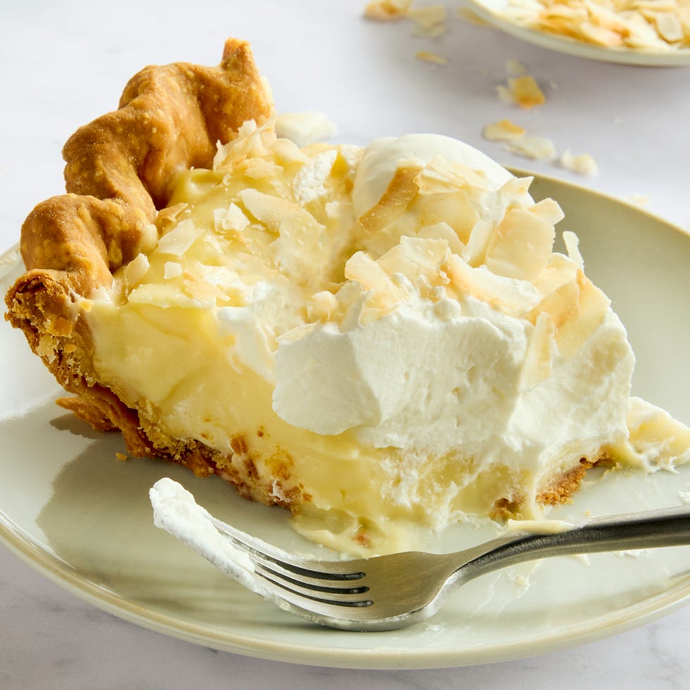 coconut cream pie topped with whipped cream and toasted coconut flakes