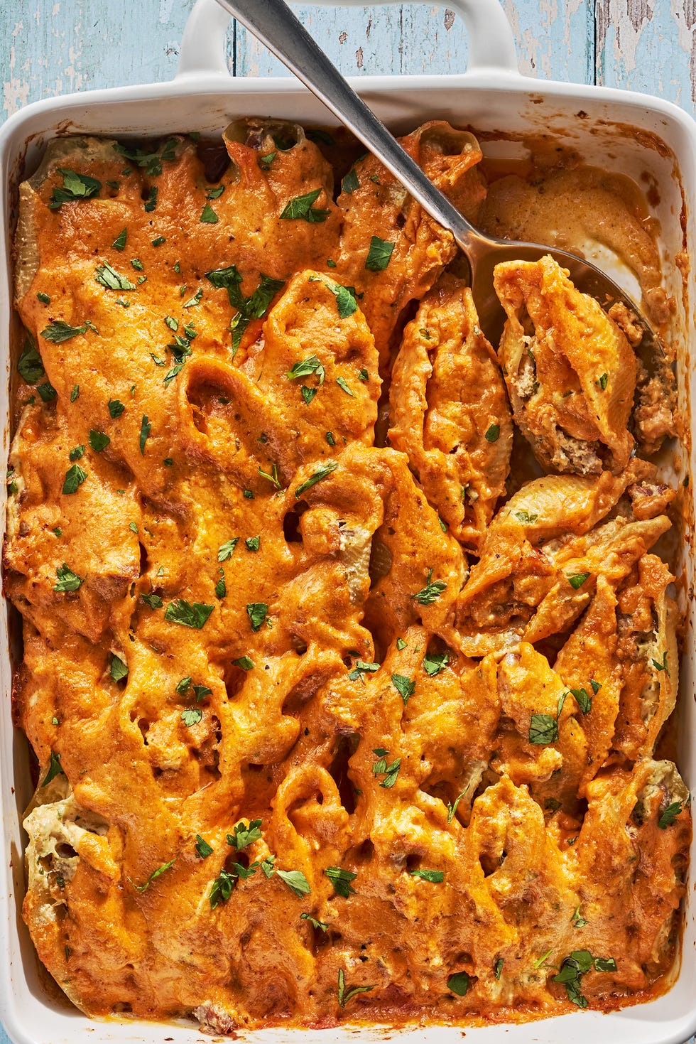 creamy cajun stuffed shells in a white baking dish