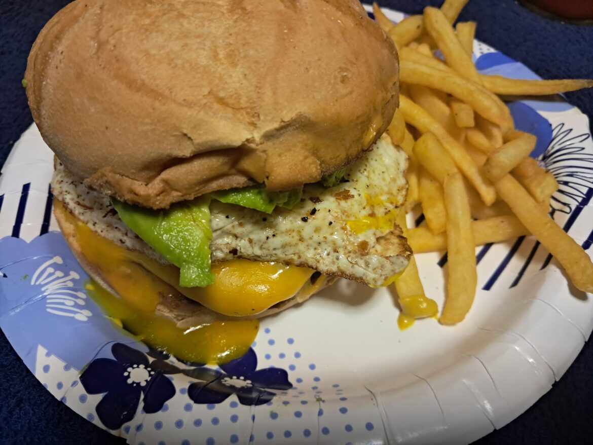 Cheeseburger with egg avocado and a Kaiser roll. The egg busted open when I put it on the burger so what