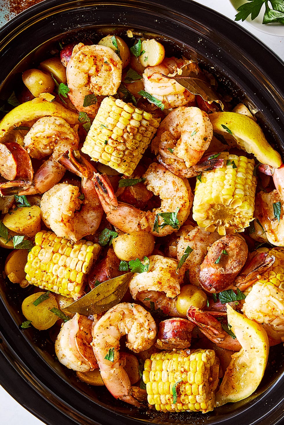 baby potatoes, sweet corn, spicy sausage, and lemons swimming in a flavorful broth with juicy shrimp tossed in plenty of old bay seasoning