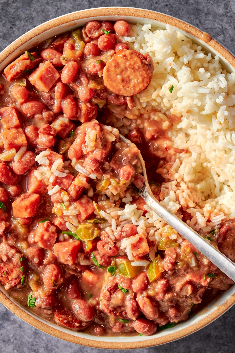 a creole classic with tender, creamy red beans stewed in smoked ham and andouille sausage and flavored with holy trinity vegetables, then served over steamed rice