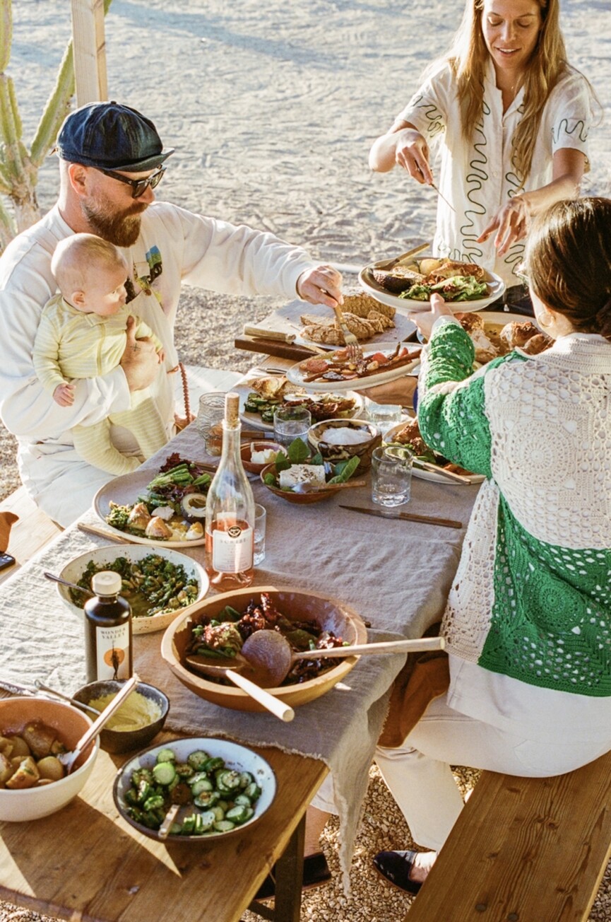 People eating al fresco at outdoor dining table.