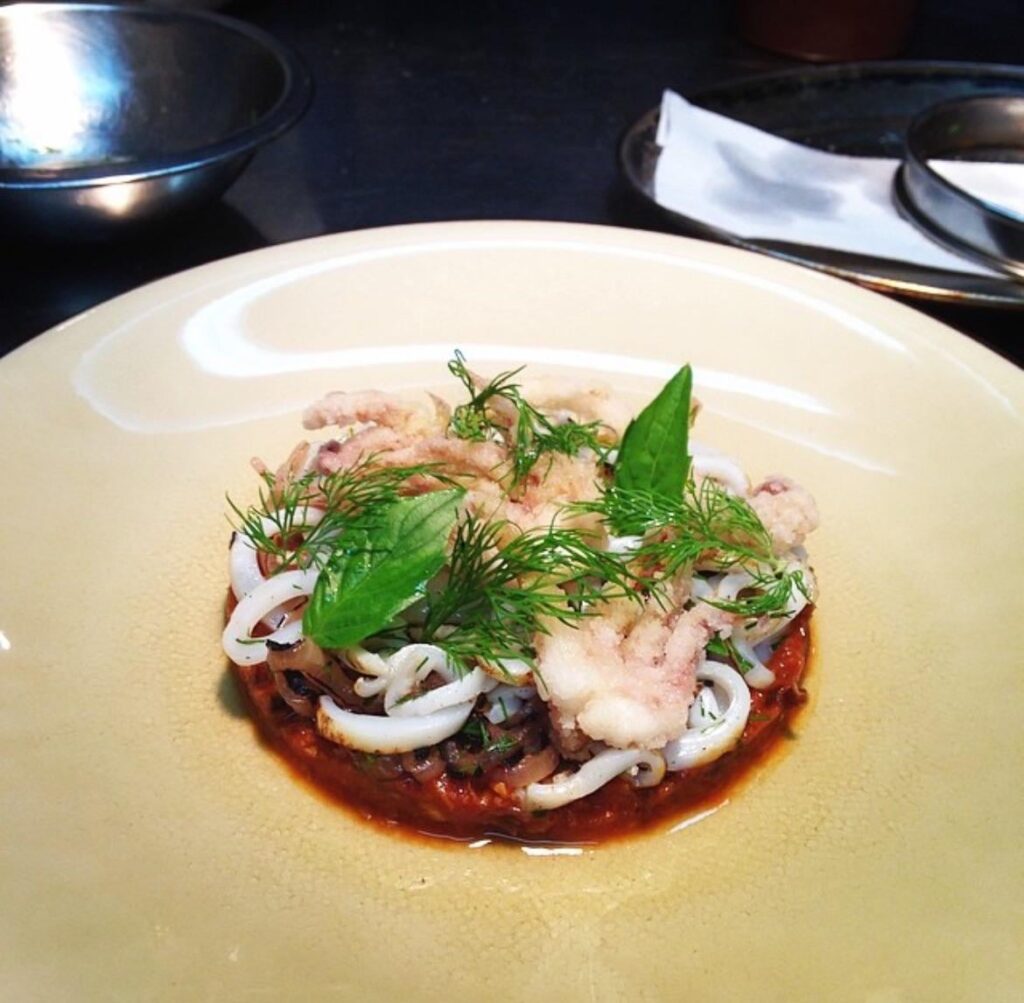 Braised pork neck ragu, grilled squid, Calabrian chili, pickled onion, dill, Thai basil 👌