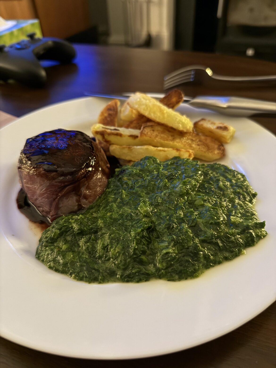 Parma ham wrapped fillet with double cooked chips and creamed spinach Parma ham wrapped fillet with double cooked chips and creamed spinach