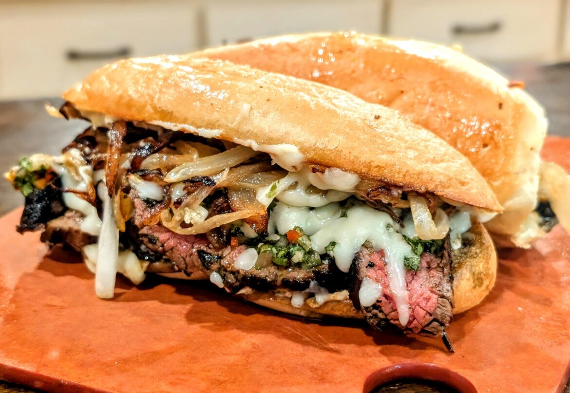 Carne asada, grilled onions, cilantro chimichurri and garlic mayo on a bolillo roll