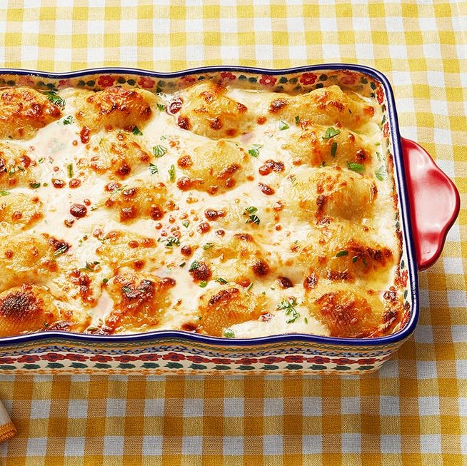 chicken alfredo stuffed shells in baking dish on yellow checkered background